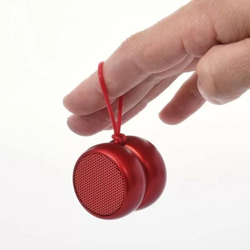 Small red wireless speaker with selfie button held by hand