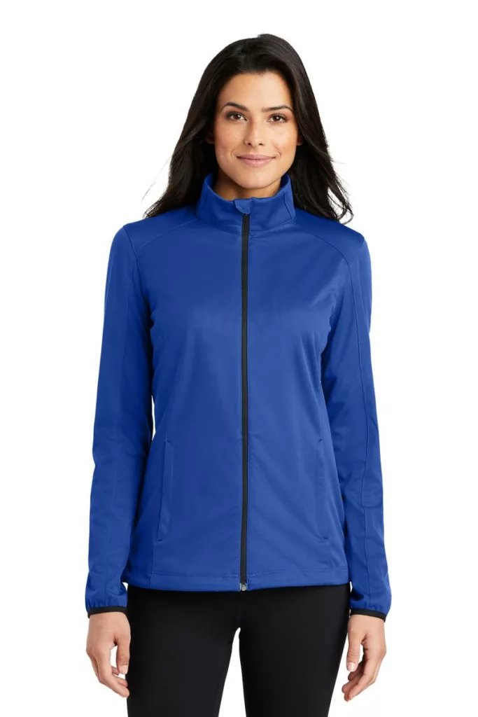 Woman wearing blue soft shell jacket with zip front closure.