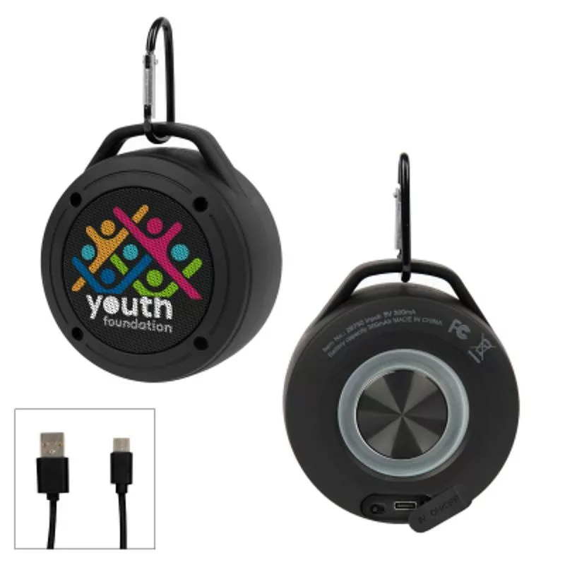 Round black Bluetooth speaker with carabiner clip and charging port.