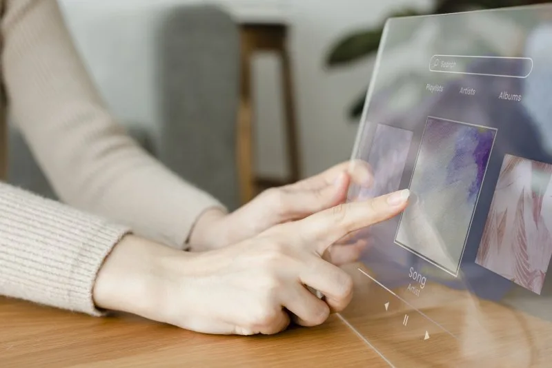 Woman using interactive digital screen display at trade show booth