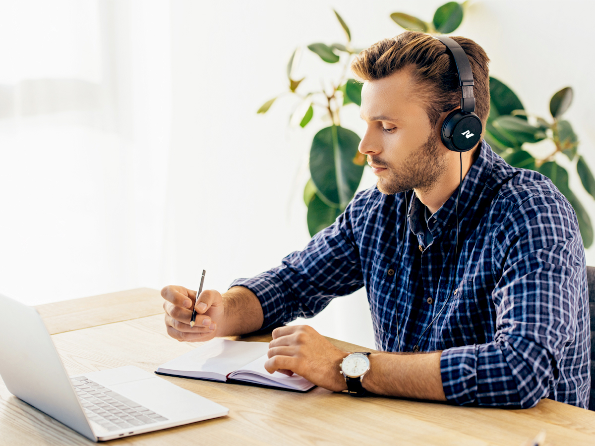 Man working at computer while listening to music