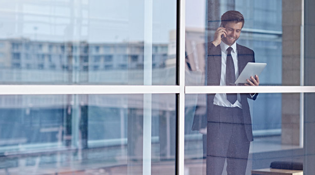 Man on phone through window