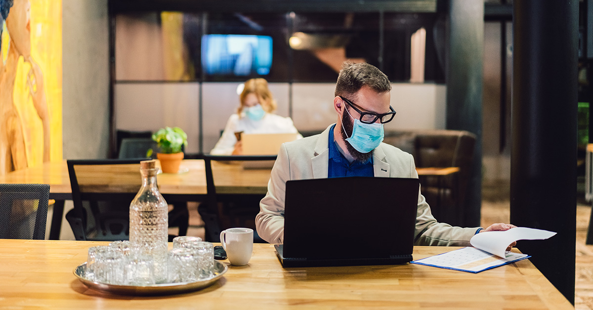 Man at computer wearing a mask