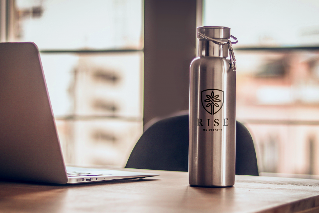 Metal branded water bottle on desk with laptop