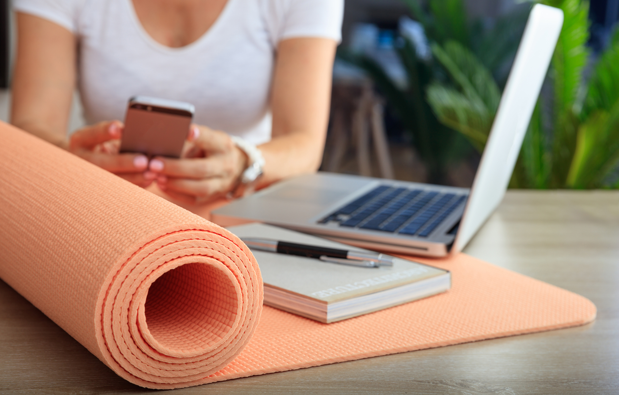 Employee enjoying employee wellness plan with yoga mat