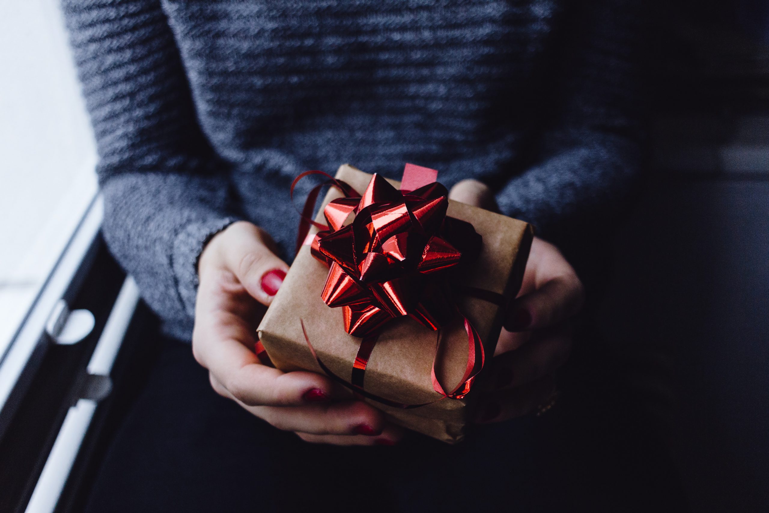 woman holding corporate holiday gift idea