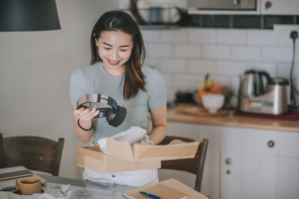 Woman opening branded tech gift.