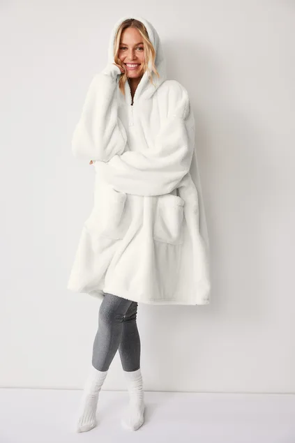 Woman wearing white oversized blanket hoodie