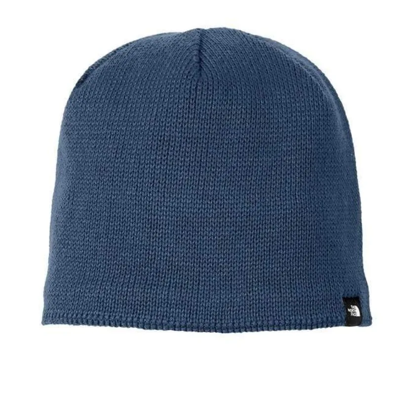 Blue North Face® knit beanie with small logo tag for outdoor wear.
