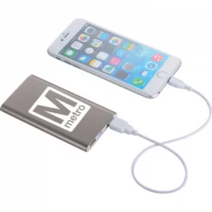 Slim metallic portable power bank charging smartphone with dual USB ports and custom logo