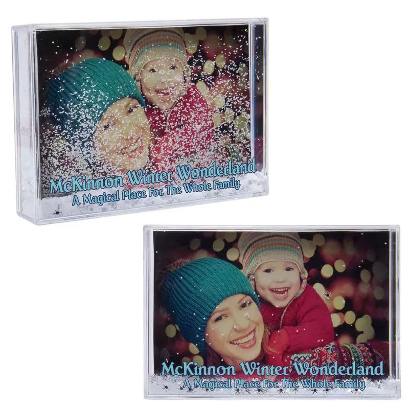 Snow globe photo frame holding family picture with swirling glitter snowflakes