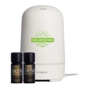 White essential oil diffuser with ambient glow light and pure oil bottles for aromatherapy