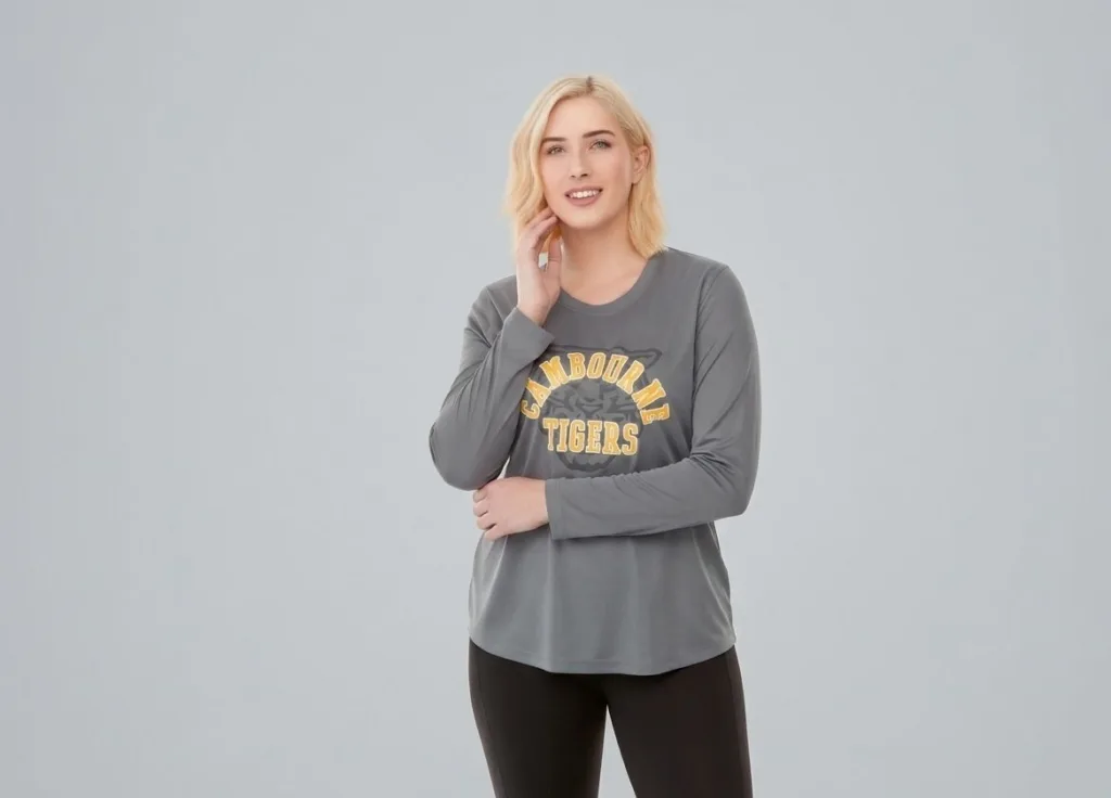 Women wearing long sleeve t-shirt with bright school logo. Logo placement on shirt is on the front center.