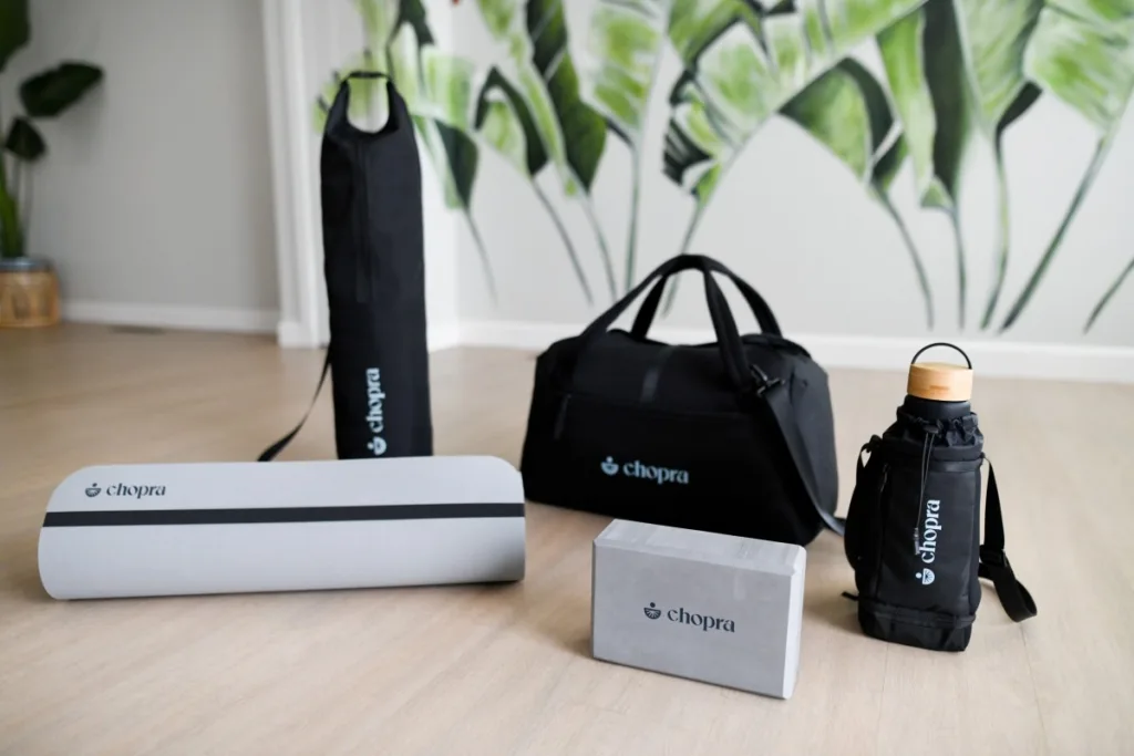 Yoga mat, duffle bag, yoga block, and water bottle in carrier bag for company anniversary gift ideas