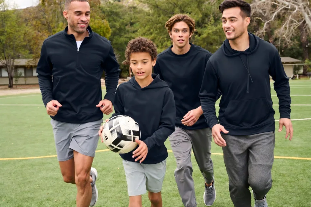 Young men aging from young adult to youth wear black hoodie merchandise for schools