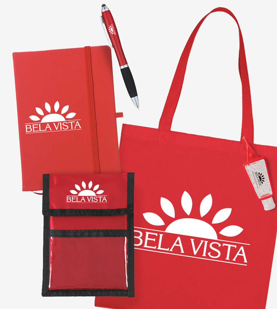 Red assortment of trade show items including a journal, pen, badge holder, tote bag, and hand sanitizer