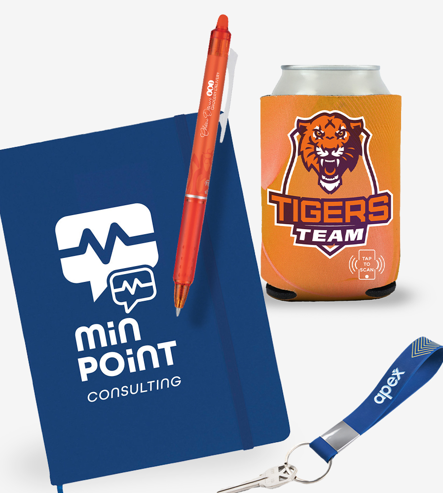 Assortment of trade show giveaways including a blue journal, orange pen, blue key tag, and orange can cooler