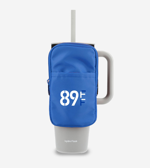 A bright blue zippered pouch designed to strap onto a large tumbler