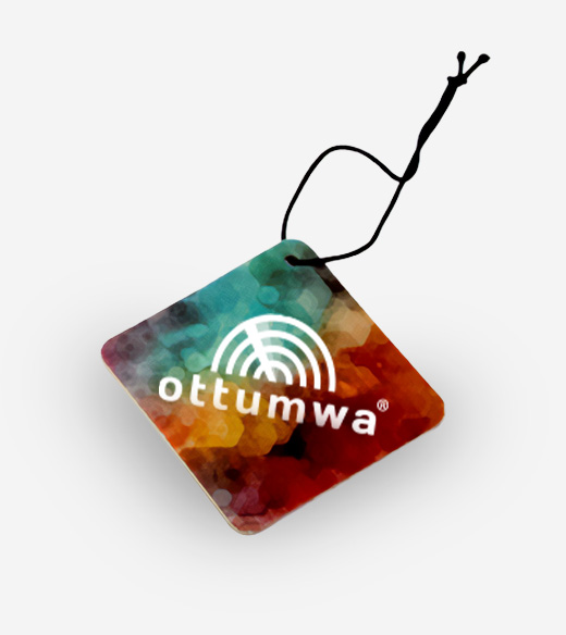 Diamond-shaped car air freshener with a colorful abstract background